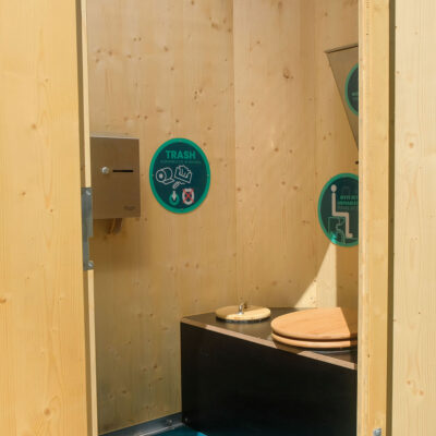 Innenansicht Humero Rollin’ mit Holzverkleidung, Trockentoilette mit Holzsitz und Edelstahl-Spender.